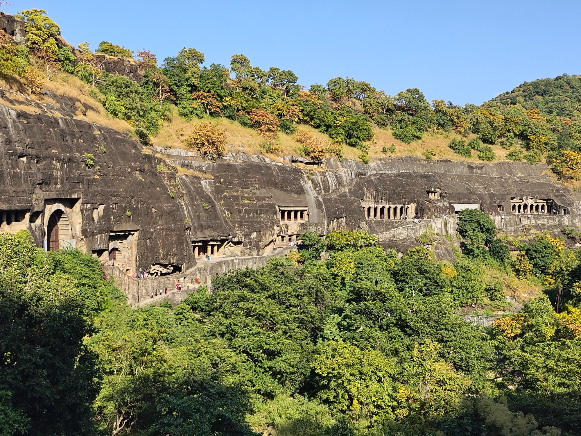 The Ajanta caves, cut into a horseshoe-shaped cliff above the river